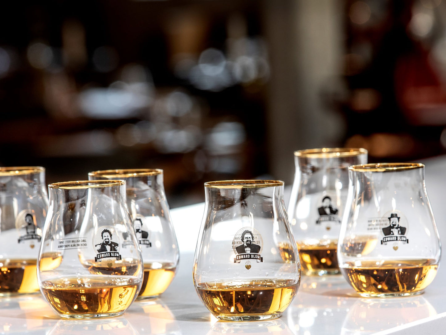 WHISKY / TASTING GLAS, Med citat, Edward Blom, Framsida, Med dryck i, Flera glas, Glasen står på ett bord, LIVET PÅ EN PINNE.